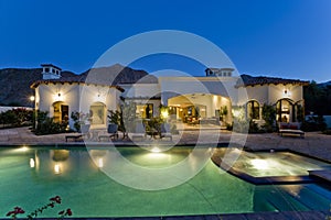 Illuminated House With Pool At Dusk