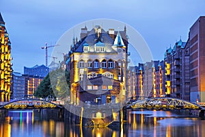 Illuminated house and two brides in Speicherstadt, Hamburg