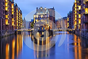 Illuminated house and two brides in Speicherstadt, Hamburg