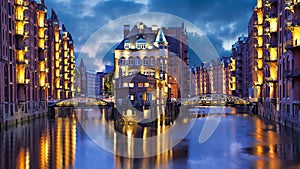 Illuminated house and two brides in Speicherstadt, Hamburg