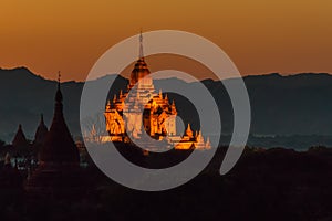 The illuminated Htilominlo temple at sunset