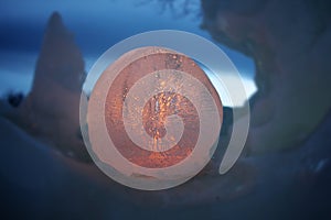 Illuminated ice ball in the middle of snow