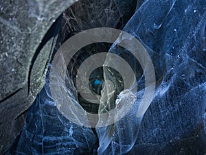 Illuminated ice in a blue glacier cave