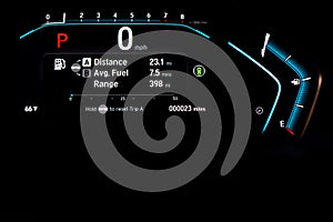 Illuminated instrument panel dashboard on new car with very low milage at only 23 miles odometer, digital display of gauges and