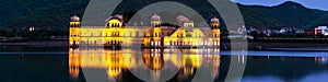 Illuminated Jal Mahal palace at night in Jaipur