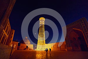 illuminated Kalyan minaret at night in Bukhara photo