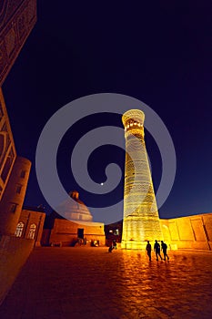 illuminated Kalyan minaret at night in Bukhara photo