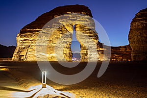 Illuminated by lamps sandstone elephant rock erosion monolith standing in the night desert, Al Ula, Saudi Arabia photo