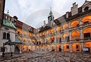 Illuminated Landhaus courtyard with a bronze fountain at sunset. Graz, Austria