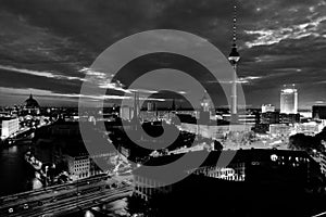 Illuminated landmarks in Berlin, Germany in the morning. Colorful cloudy sky at sunrise. Black and white