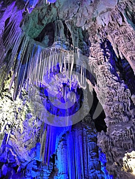 Illuminated limestone caves and stalagmite formations in St. Michael\'s Caves, Gibraltar