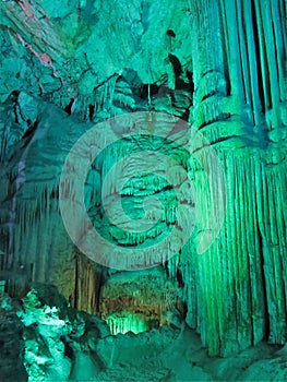 Illuminated limestone caves and stalagmite formations in St. Michael\'s Caves, Gibraltar