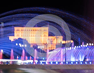 Illuminated main fountain and people`s house Parliament House in Bucharest, Romania, 07.23.2020