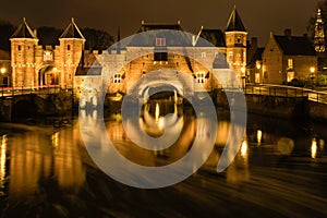 Illuminated medieval gateway Koppelpoort at night, Amersfoort the Netherlands