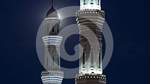 Minarets of The Hazrat Sultan Mosque in Astana timelapse at night with full moon, Kazakhstan photo