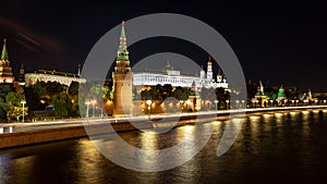 Illuminated Moscow at night with the Moskva River in the foreground and the Kremlin with its wall, towers, church and