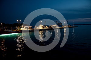 Illuminated Motorboats At Jetty In Calm Harbor In Croatia