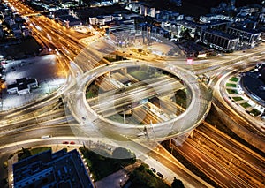 A illuminated multilevel highway junction interchange during night time