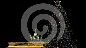 Illuminated Neoclassical Brandenburg Gate Brandenburger Tor and Christmas Tree in the year 2019 as viewed from the Pariser Platz