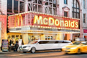 Illuminated neon sign of burger chain Mc Donalds on 42nd Street in Manhattan