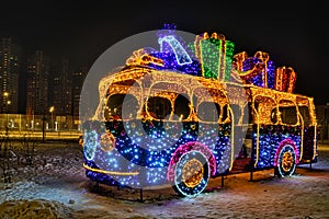 Illuminated New Year Bus With Gifts at Night