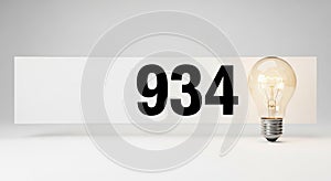 Illuminated number 934 with light bulb