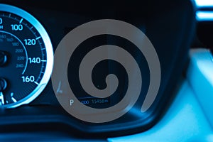 Illuminated odometer on dashboard warning area near speedometer when car in parking mode of new modern auto vehicle