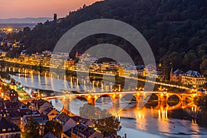 Illuminated old bridge leading to the Holy Spirit church in Heidelberg, Germany