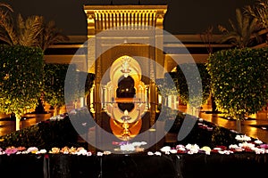 Illuminated oriental style entrance with geometric patterns and water basin of Hotel Mazagan Beach Resort, Morocco. Night shot.