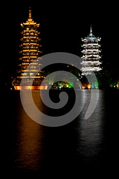 Illuminated Pagodas reflecting on water at night