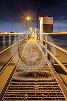 Illuminated pier on large steel mooring posts