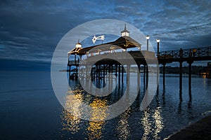 Illuminated pier over the lake at sunset