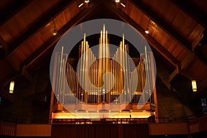 illuminated pipe organ in an otherwise dark church hall