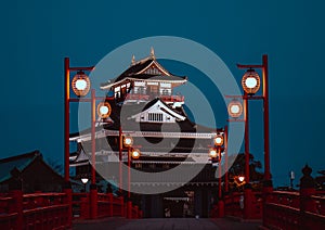 Illuminated red bridge with Kiyosu Castle in the background. Aichi Prefecture, Japan.
