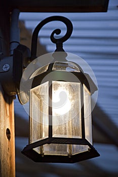 Illuminated rustic lantern on the porch