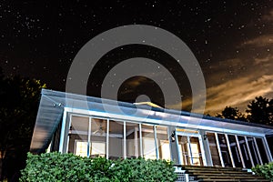 Illuminated screened porch against night sky