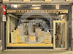 Shop window of a vintage wallpaper shop at night in Ghent