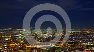 Illuminated Skyline of Tehran Against Dark Blue Sky