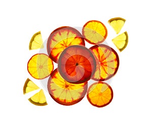 Illuminated slices of citrus fruits on white background