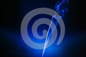 Illuminated smoke with a blue and black background