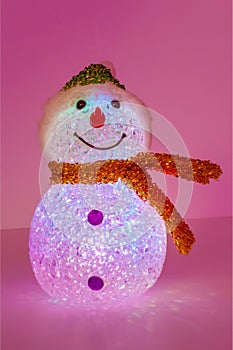 Illuminated snowman on pink background