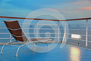 Illuminated solitary deck-chair on ship