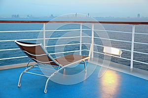Illuminated solitary deck-chair on ship