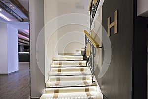 Illuminated stairs in empty corridor