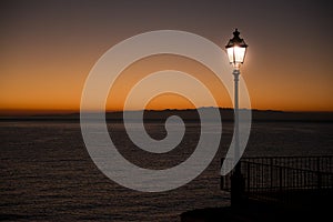 Illuminated street lamp during the sunset