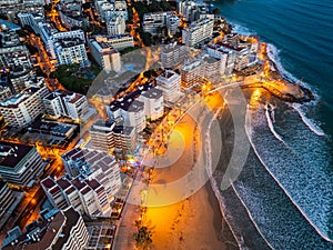 illuminated streets of Spanish touristic city Salou, Catalonia, aerial view of beach, sea and coast with palm trees