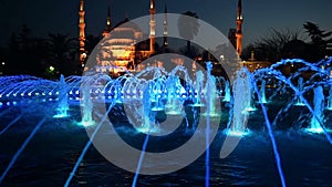Illuminated Sultan Ahmed Mosque Blue Mosque before sunrise, View of the evening fountain. Istanbul, Turkey
