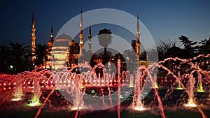 Illuminated Sultan Ahmed Mosque Blue Mosque before sunrise, View of the evening fountain. Istanbul, Turkey