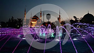 Illuminated Sultan Ahmed Mosque Blue Mosque before sunrise, View of the evening fountain. Istanbul, Turkey