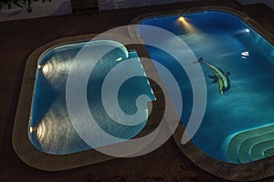 illuminated swimming pools at night